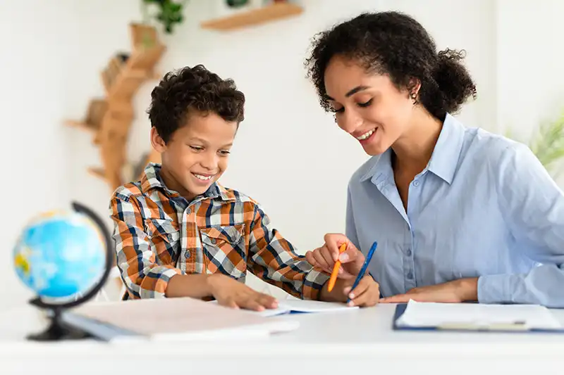 woman tutoring child