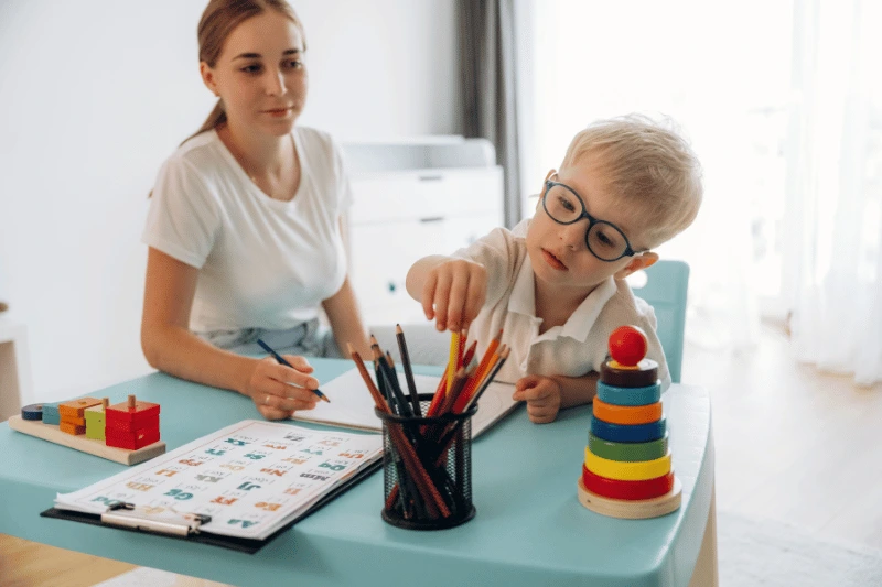 Child working with an ABA therapist during a learning activity in Frederick, MD