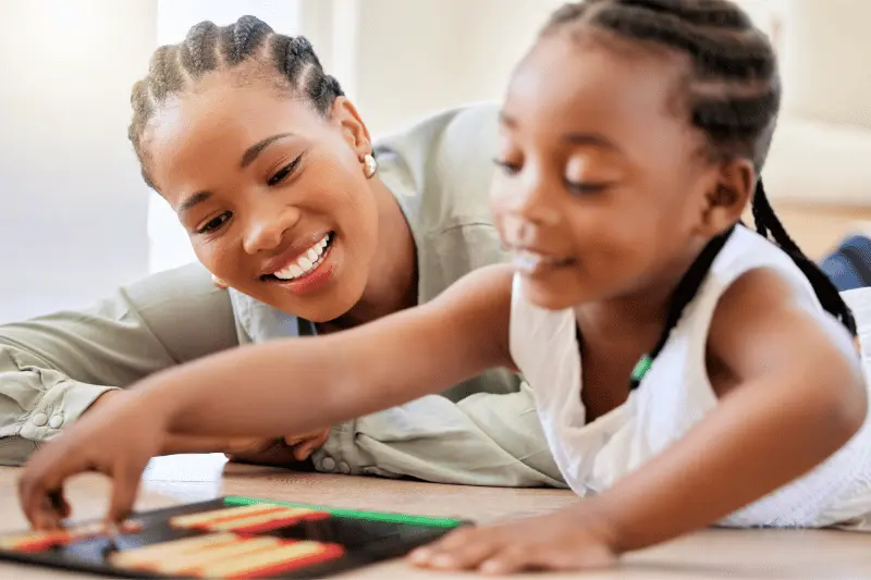 Parent and child playing a tabletop game together at home